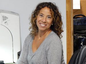 A woman sitting at a desk in front of a computer.