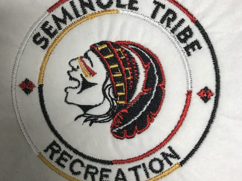 Seminole tribe recreation logo embroidered on a white shirt.